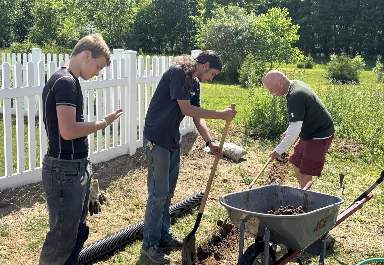 Students digging a new garden bed together